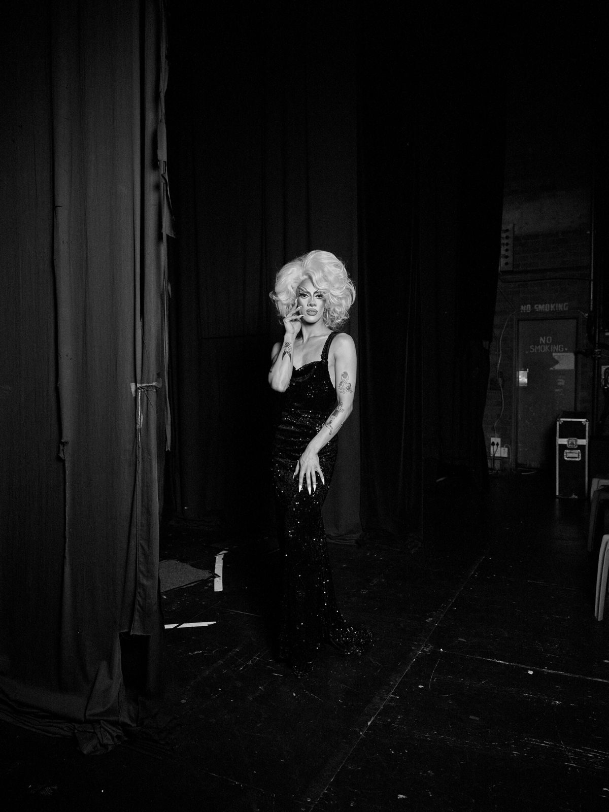 Black and white photo of Ina Propriette backstage in a sequinned gown
